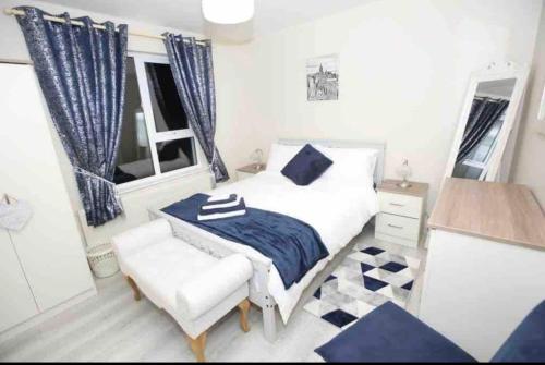 a bedroom with a bed and a chair and a window at “John Bs” 1 Bedroom Apartment in Ardara in Ardara