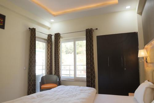 a bedroom with a bed and a window at Kingdom Heartz, Bhimtal, Nainital in Bhīm Tāl