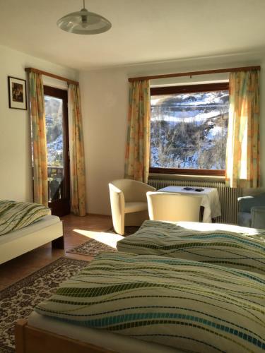 a bedroom with a bed and a couch and a window at Guesthouse Mountain View in Großkirchheim