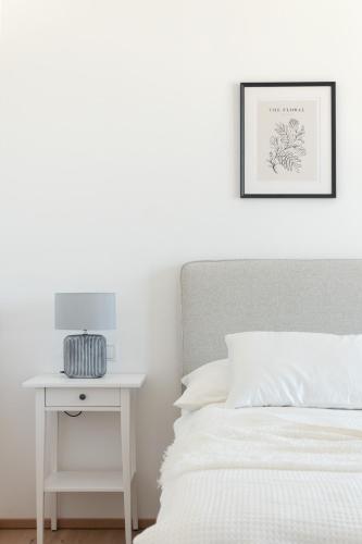 a bedroom with a bed and a nightstand with a table at Sophienne Apartments in Vienna