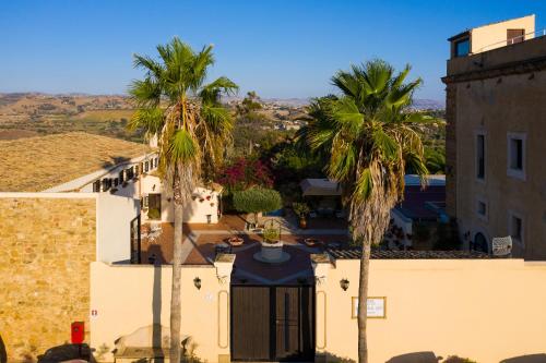 an aerial view of a building and palm trees at Hotel Foresteria Baglio Della Luna in San Leone