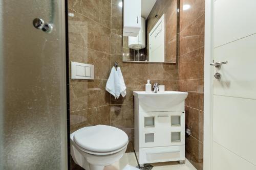 a bathroom with a toilet and a sink at Apartments Dabinovic in Kotor