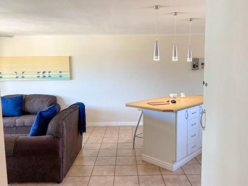 a living room with a couch and a table at 9 Summerplace in Knysna