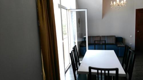 a table and chairs in a room with a window at Vacation House in Truskavets