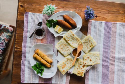 a table with two plates of food with corn dogs at Topset Hotel in Kérynia