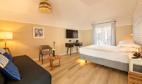 a bedroom with a bed and a living room at Pestana Fisherman Village in Câmara de Lobos