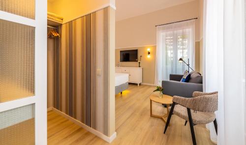 a living room with a bed and a living room with a table at Pestana Fisherman Village in Câmara de Lobos