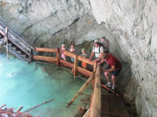 a group of people standing on a bridge in a cave at Appartements Hochzillertal in Kaltenbach