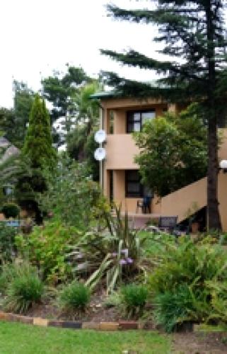 a building with a garden in front of it at St Michelle Guest Lodge & Hydro Retreat in Alberton