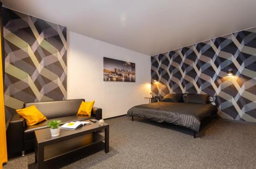 a bedroom with a bed and a couch and a table at Samira 2 in Kyiv