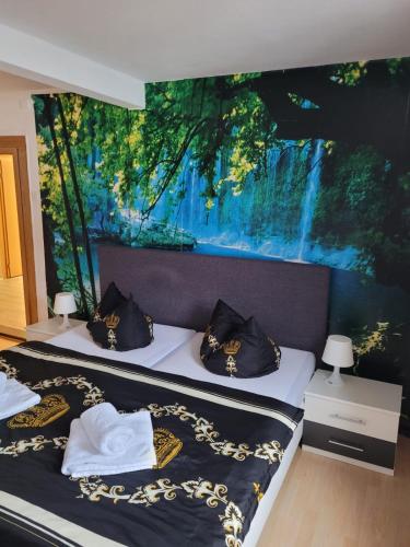 two beds in a room with a painting on the wall at Pension Parkblick in Braunlage