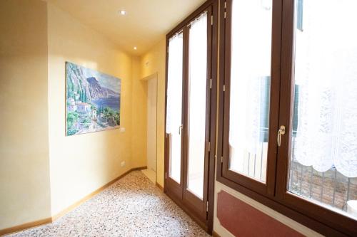 an empty hallway with a door and a window at Alla Vigna - Room Only in Venice