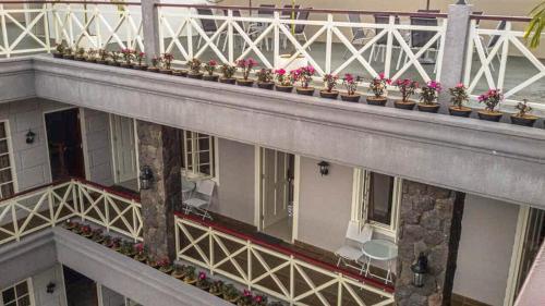 a balcony with potted plants on a building at Rosetta Homestay in Batu