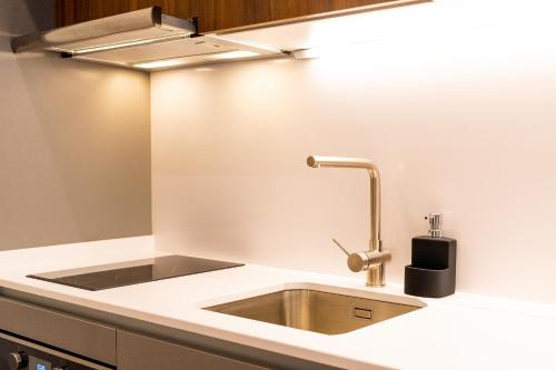a kitchen sink with a light above it at Oliva Teles 53 - Sophia Terrace in Arcozelo