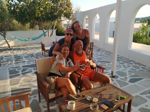 a group of people sitting in chairs on a patio at Aliki Panorama Rooms -breakfast included- in Aliki