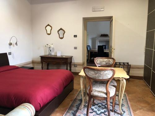 a bedroom with a bed and a table and chairs at Villa Dell'Annunziata in Rieti