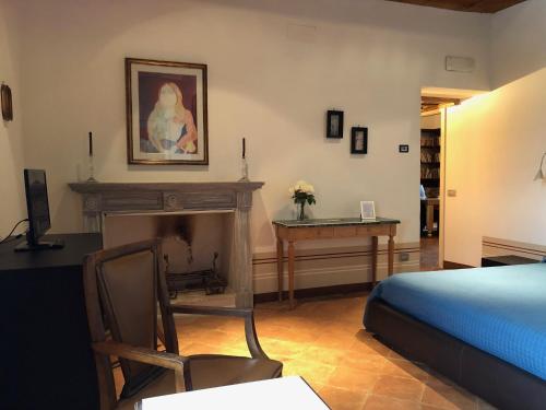 a bedroom with a bed and a fireplace and a desk at Villa Dell'Annunziata in Rieti