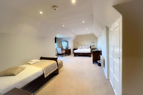 a hotel room with two beds and a bedroom at Castle Bromwich Hall; Sure Hotel Collection by Best Western in Birmingham