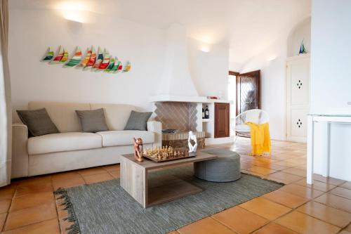 a living room with a couch and a table at Infinite Blue Porto Cervo in Porto Cervo