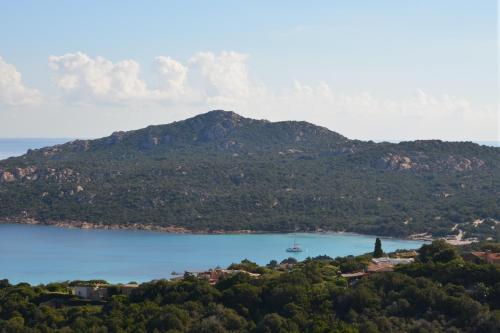 a view of a large body of water with a mountain at Infinite Blue Porto Cervo in Porto Cervo