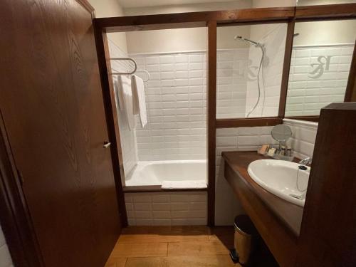 a bathroom with a tub and a sink and a shower at Rectoral de Cines in Oza dos Ríos
