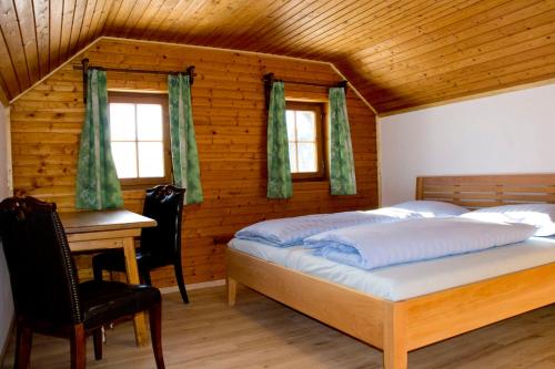 a bedroom with two beds and a desk in a room at Ruphäusl in Ramsau am Dachstein