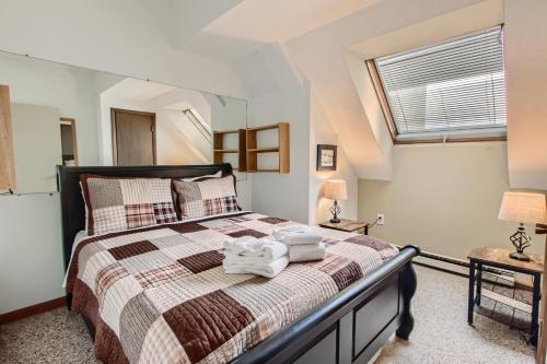 a bedroom with a bed with towels on it at Mountain Green, Condos at Killington in Killington