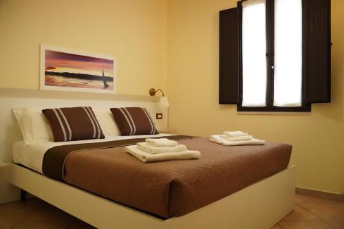 Un pat sau paturi într-o cameră la Tenuta Colle Degli Ulivi