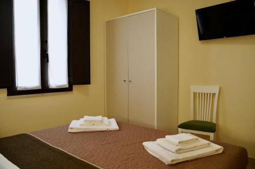En eller flere senge i et værelse på Tenuta Colle Degli Ulivi