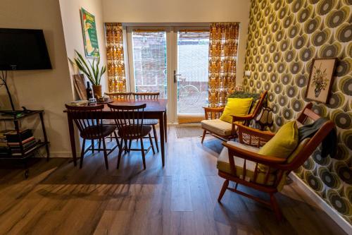 a living room with a dining room table and chairs at SOEPP hotel & restaurant in Alkmaar