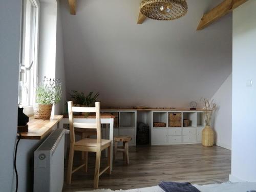 a kitchen with a table and chairs in a room at Polne Zacisze in Lgiń