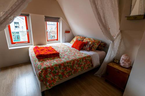 a bedroom with a bed and a window at SOEPP hotel & restaurant in Alkmaar