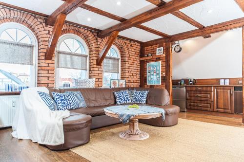 a living room with a couch and a table at Apartamenty Sea Sea in Ustka