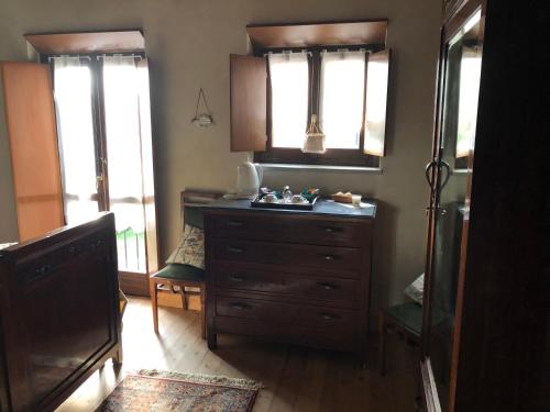 - une chambre avec une commode et 2 fenêtres dans l'établissement RESIDENZA CIMA LE VIGNE, à Millesimo