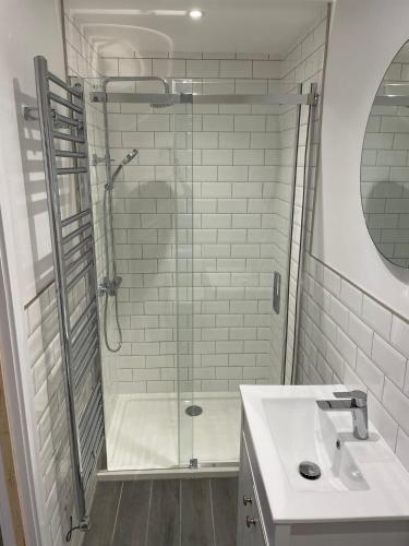 a bathroom with a shower and a sink at Bay view apartment in Penzance