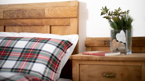 a pillow and a plant on a table next to a bed at Hotel Compagnoni in Santa Caterina Valfurva