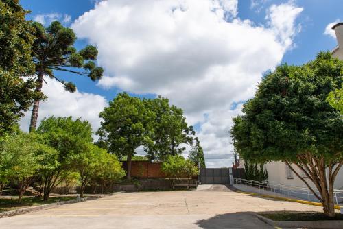 a parking lot with trees and a building at Pousada dos Frades in Garibaldi