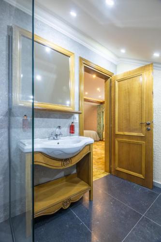 a bathroom with a sink and a mirror at HANU VISOIANU in Lunca Cetăţuii