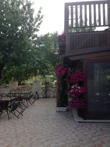 a patio with tables and chairs and flowers at Agriturismo Capriccio Di Giove in Cansano