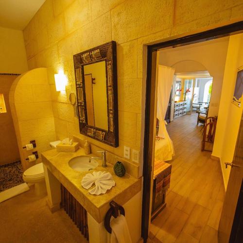 a bathroom with a sink and a mirror at Espuma Hotel - Adults Only in Zihuatanejo