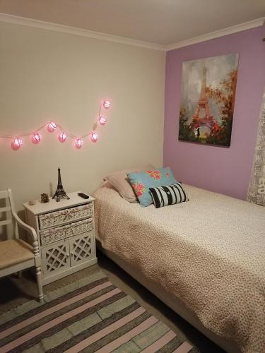a bedroom with two beds and a table and a lamp at Depto Ambiente Privado con Vista al Mar in Concón