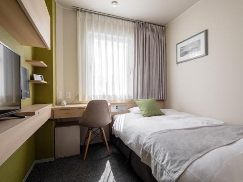Ένα ή περισσότερα κρεβάτια σε δωμάτιο στο Fujieda Park Inn Hotel