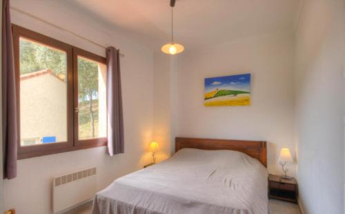 a bedroom with a bed and a window at Gîtes Carbuccia en Corse avec piscine chauffée in Carbuccia