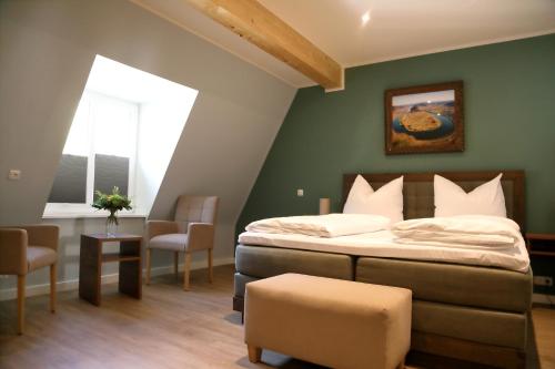 a bedroom with a bed and a table and chairs at Pension Moselvilla 1900 in Cochem