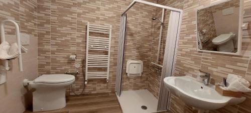 a bathroom with a toilet and a sink at Locanda della Luna in Ronco Canavese