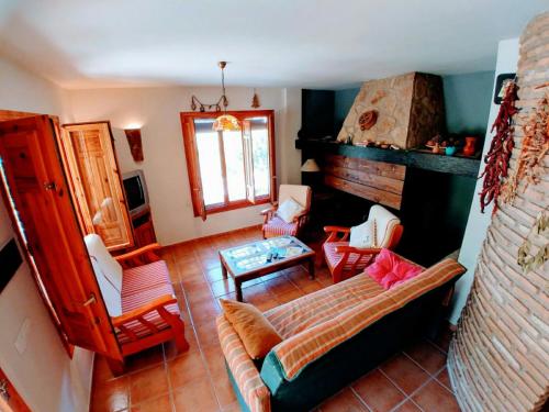 卡索拉爾的住宿－CAZORLA, CASA RURAL LA GUINDALERA，客厅配有沙发和椅子