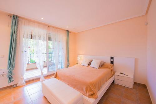 a bedroom with a bed and a large window at Bungalow Azalea - PlusHolidays in Calpe