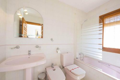 a bathroom with a toilet and a sink and a tub at Villa Cactus - PlusHolidays in Calpe