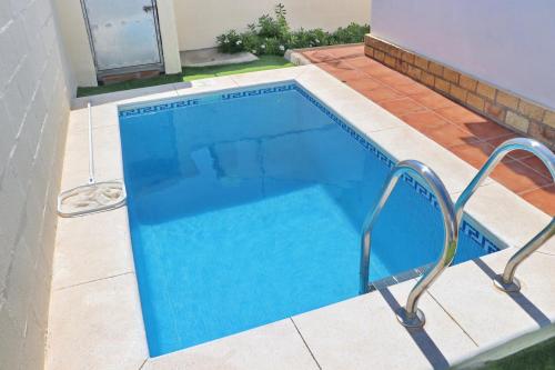 a swimming pool with blue water in a house at Chalet Chaparrillo in Conil de la Frontera