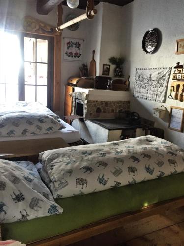 a room with two beds and a table in a room at Romantická drevenica in Liptovská Osada
